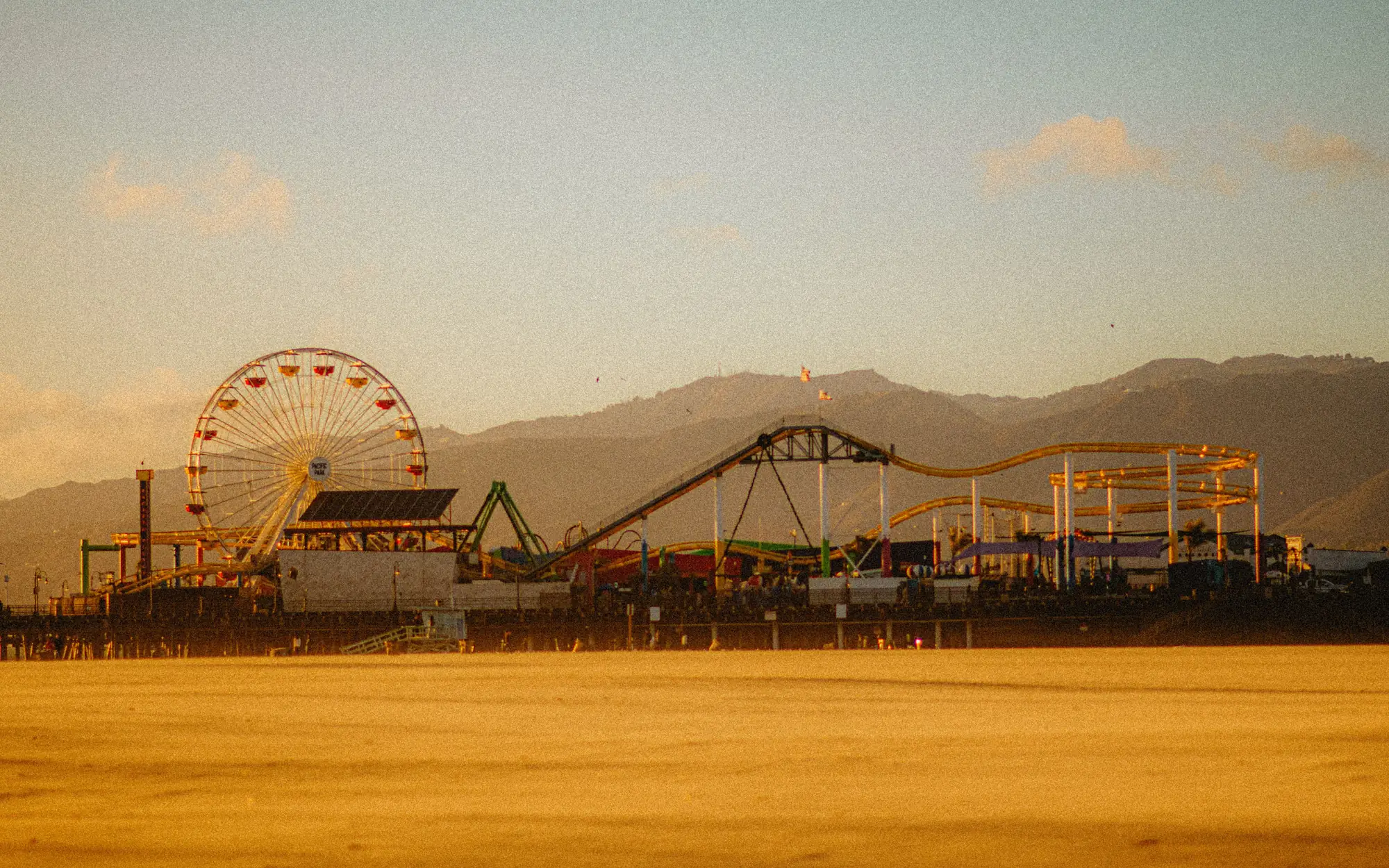 Santa Monica Pier with its Ferris wheel and roller coaster at dusk, Santa Monica, California