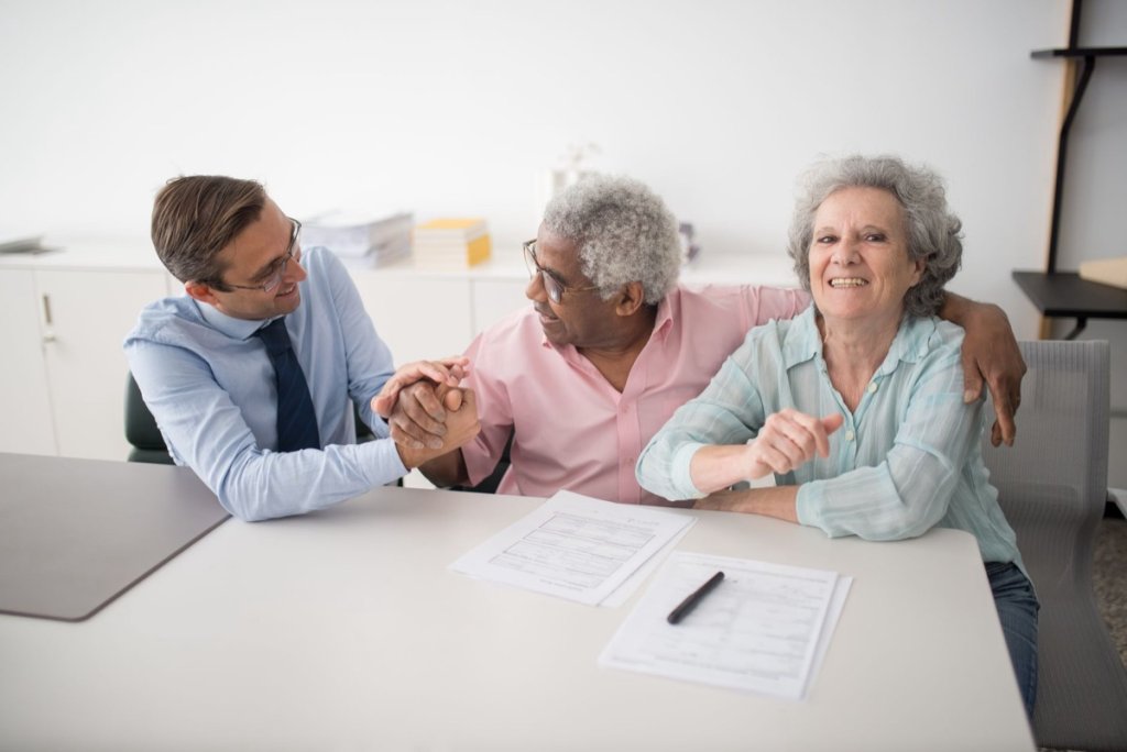 A matchmaker going through the contract questions with a couple in her office